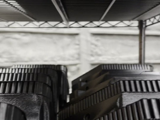 Shelf of finished 3D-printed cup holders sized for Yeti tumblers